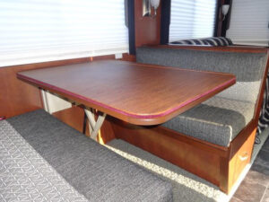 RV dining table with custom table pad setting on top. 